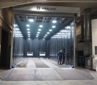 Airblast blast room at K-two manufacturing facility, featuring a full recovery floor, ATEX lighting, and roller door.