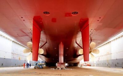 Underside of a freight ship in a dry dock.