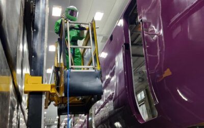 Operator processing rolling stock inside a blast room, at Hitachi rails Newton Aycliffe HQ, designed & installed by Airblast.