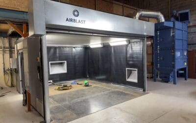 The blast room enclosure at Hydro International, it's roller door open, showing the interior.