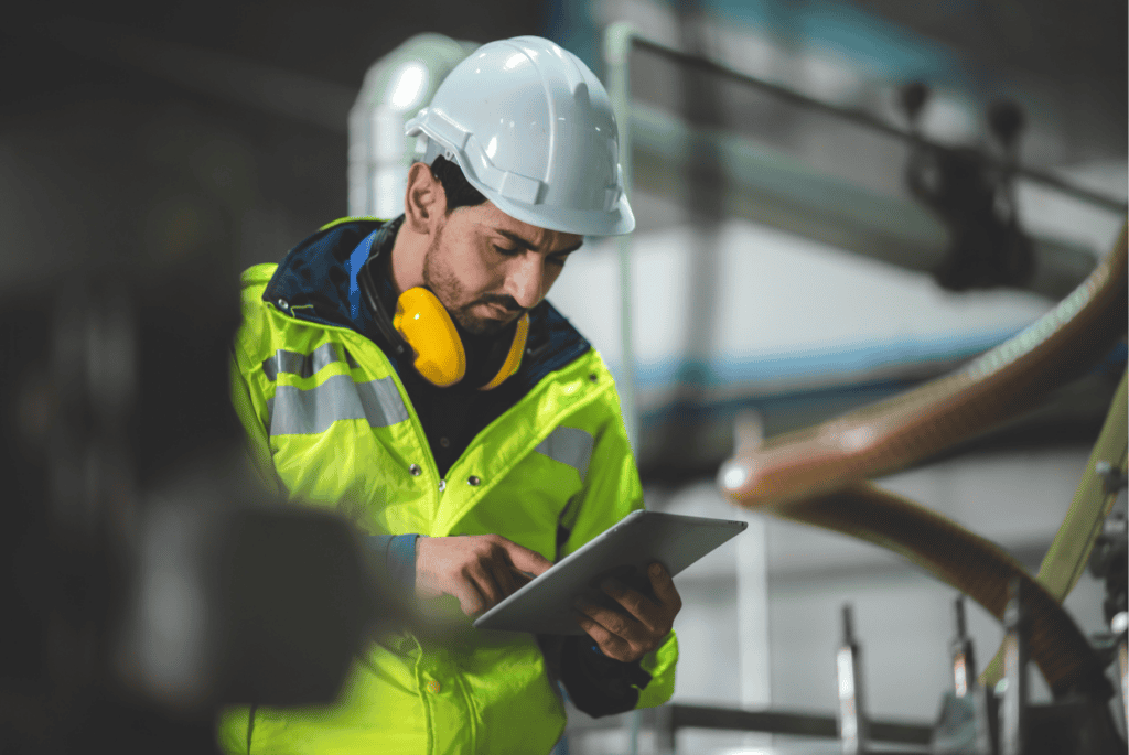 Factory worker conducting health and safety checks on equipment.