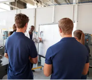 Technicians recieving training inside a factory.