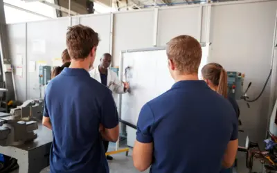 Technicians recieving training inside a factory.