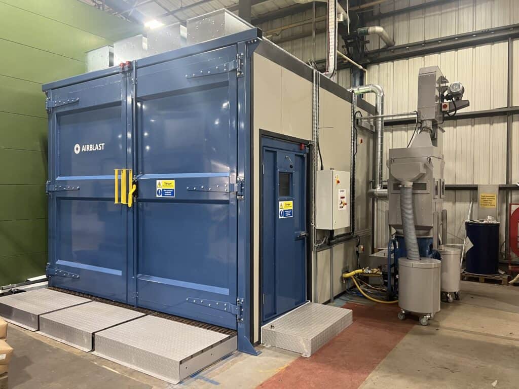 Sound attenuated blast room with rail loading system.