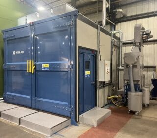 Sound attenuated blast room with rail loading system.