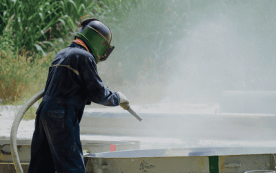 Surface preparation being conducted outside by a man in full PPE