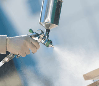 Upclose shot of someone using a spray gun.